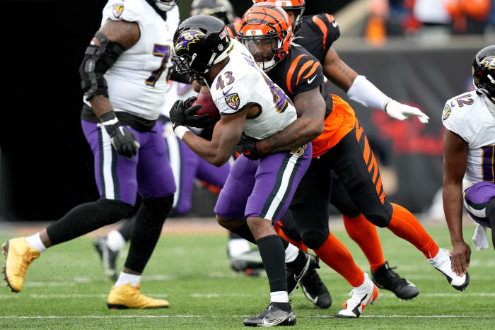 Jan 8, 2023; Cincinnati, Ohio, USA; Cincinnati Bengals linebacker Germaine Pratt (57) tackles Baltimore Ravens running back Justice Hill (43) in the second quarter during a game at Paycor Stadium. Mandatory Credit: Kareem Elgazzar-USA TODAY Sports